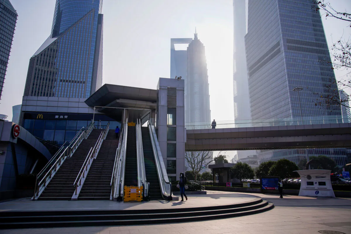 People wearing masks are seen at Lujiazui financial district in Pudong, as the country is hit by an outbreak of a new coronavirus, in Shanghai, China, on Feb. 3, 2020. (Aly Song/Reuters)