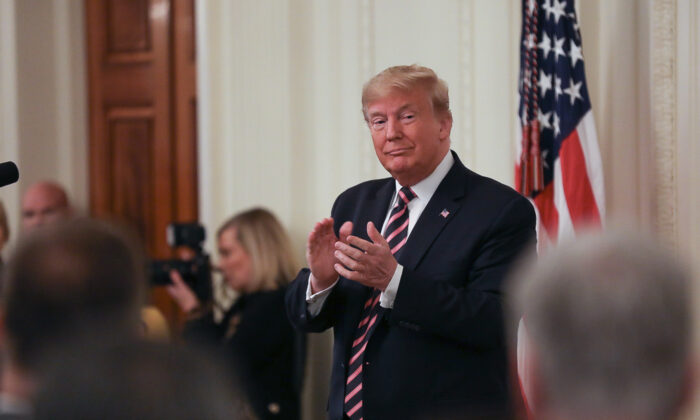 President Donald Trump applauds a day after being acquitted in two articles of impeachment, in the East Room of the White House in Washington on Feb. 6, 2020. (Charlotte Cuthbertson/The Epoch Times)