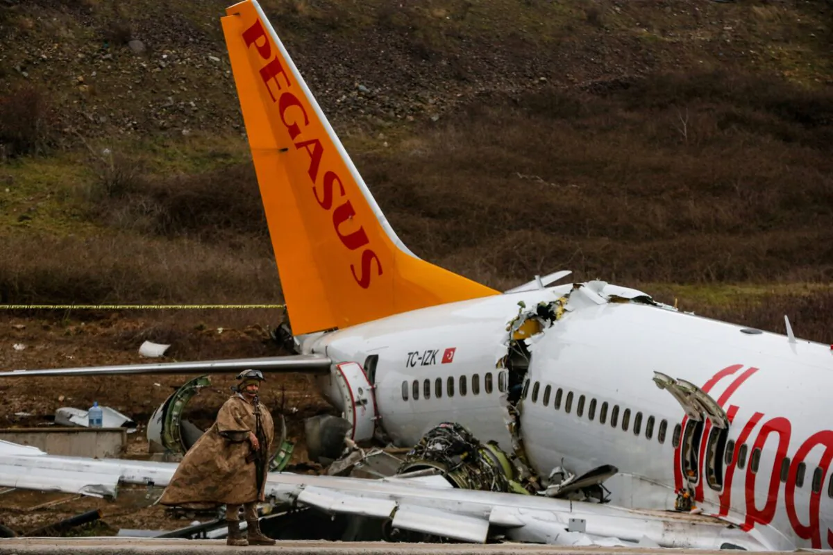 Soldiers guard the wreckage of a plane operated by Pegasus Airlines after it skidded Wednesday off the runway at Istanbul's Sabiha Gokcen Airport, in Istanbul, Turkey, on Feb. 6, 2020.(Emrah Gurel/AP)
