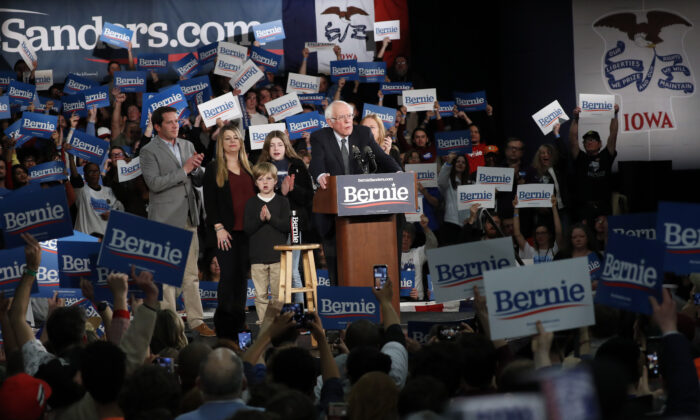 Democratic presidential candidate Sen. Bernie Sanders (I-Vt.) accompanied by his family, speaks to supporters at a caucus night campaign rally in Des Moines, Iowa, on Feb. 3, 2020. (Pablo Martinez Monsivais/AP Photo)