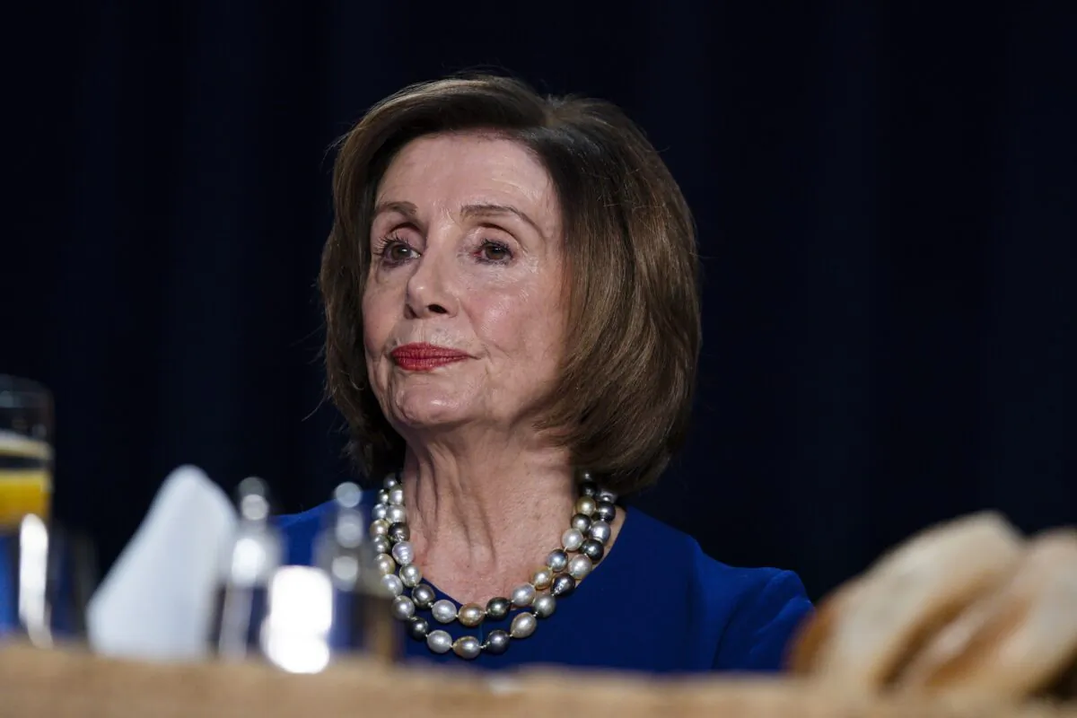 House Speaker Nancy Pelosi (D-Calif.) listens as President Donald Trump speaks at the 68th annual National Prayer Breakfast, at the Washington Hilton on Feb. 6, 2020. (Evan Vucci/AP Photo)