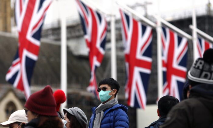 People wearing face masks are pictured on Parliament Square, on Brexit day, in London, Britain, on Jan. 31, 2020. (Simon Dawson/Reuters)