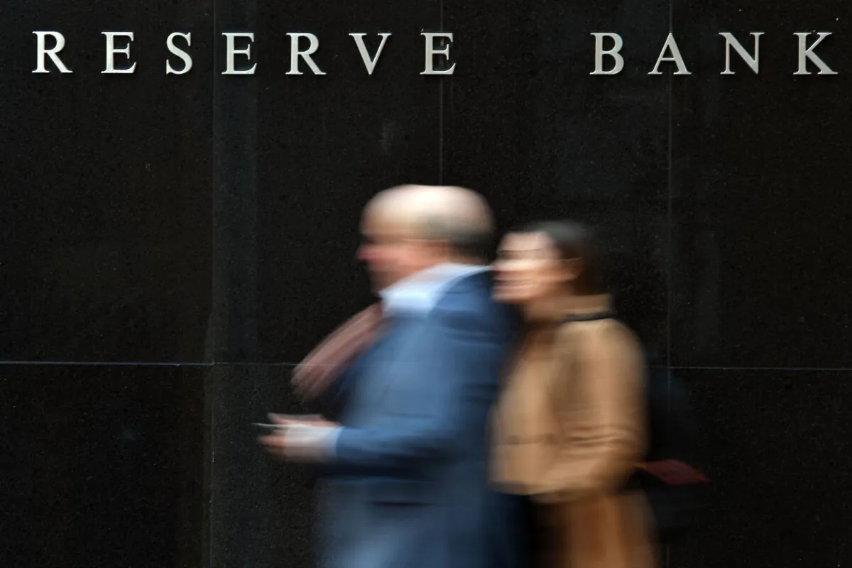 People walk past the Reserve Bank of Australia building in Sydney on May 7, 2019. (Saeed Khan/AFP via Getty Images)