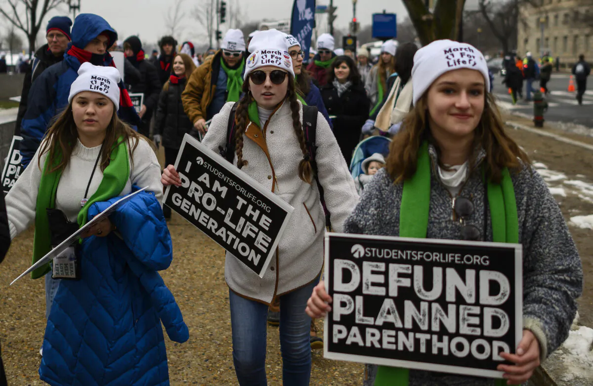 Students and activists carry signs during the annual "March for Life" in Washington, DC on January 18, 2019. (Photo by ANDREW CABALLERO-REYNOLDS / AFP)        (Photo credit should read ANDREW CABALLERO-REYNOLDS/AFP via Getty Images)