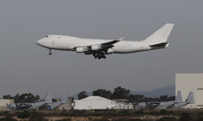 A plane carrying evacuees from the virus zone in China lands at Marine Corps Air Station Miramar, in San Diego,on Feb. 5, 2020. (Gregory Bull/AP)