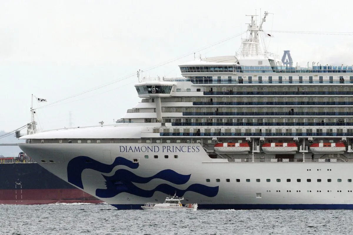 A boat navigates near the Diamond Princess cruise ship anchored off the Yokohama Port near Tokyo on Feb. 4, 2020. (Eugene Hoshiko/AP Photo)