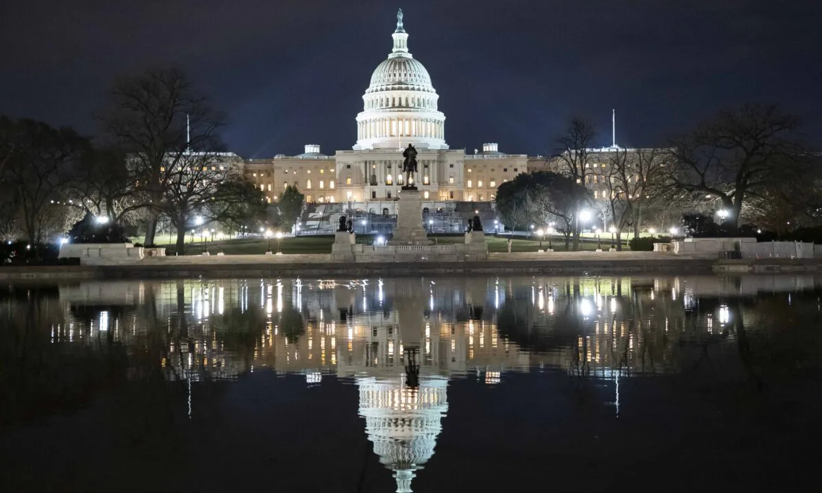 The U.S. Capitol is reflected in the Capitol Reflecting Pool shortly after midnight in Washington on Feb. 5, 2020. (Daniel Pierce Wright/Getty Images)
