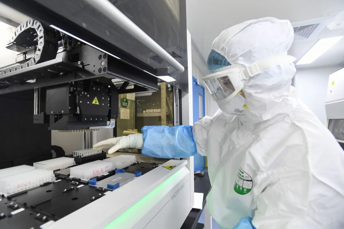 A laboratory technician working on samples from people to be tested for the new coronavirus at "Fire Eye" laboratory in Wuhan in central China's Hubei Province on Feb. 6, 2020. (STR/AFP via Getty Images)