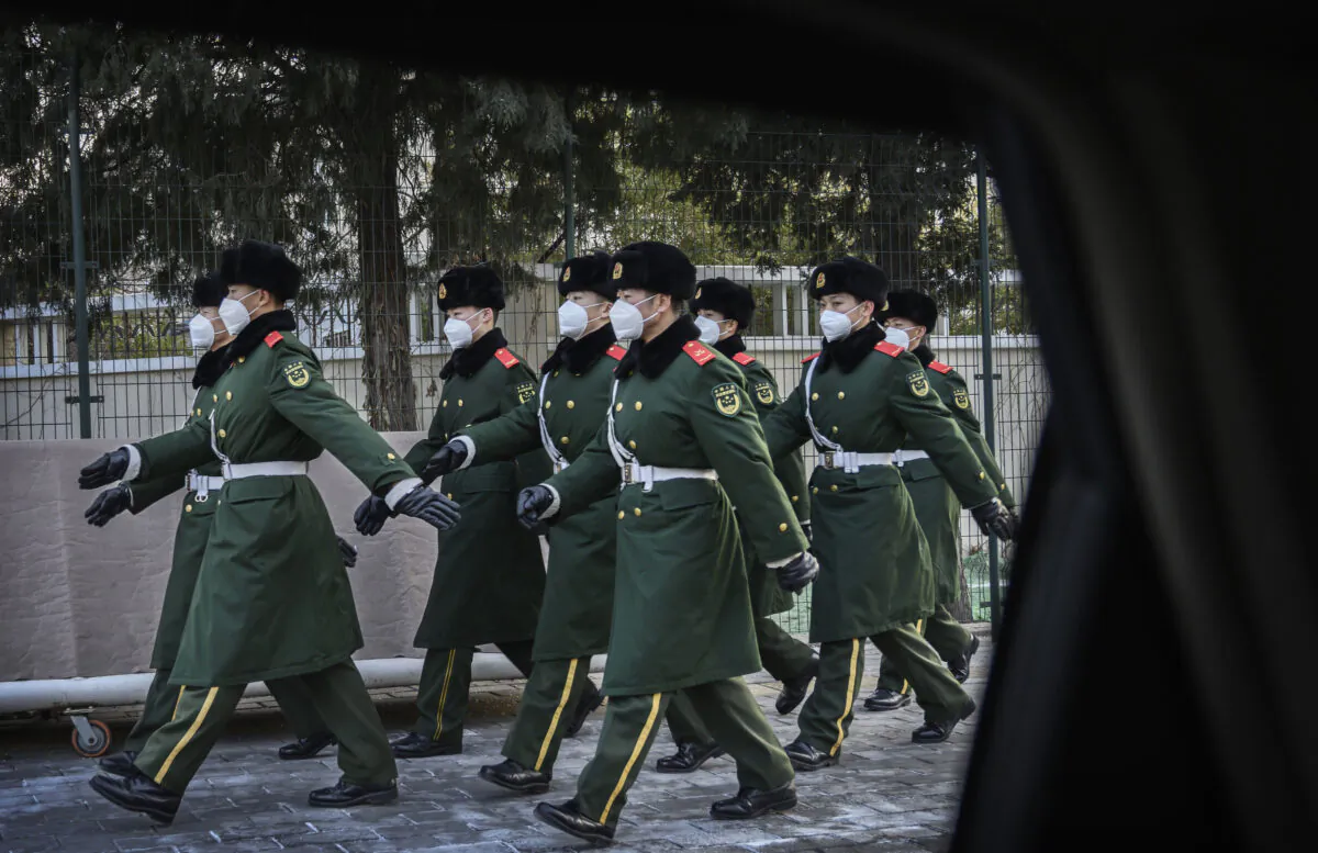 Chinese police march wearing masks during a duty change in Beijing on Feb. 3, 2020. (Kevin Frayer/Getty Images)