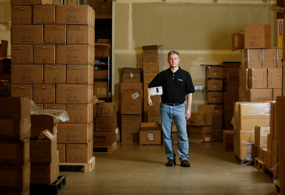 Bernie Thompson of Plugable Technologies holds a docking station that he sells on Amazon.com from his facility in Redmond, Washington, U.S., on Feb. 6, 2020. (Lindsey Wasson/Reuters)
