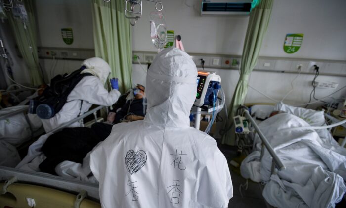 Medical workers in protective suits attend to patients with the new coronavirus inside an isolated ward at a hospital in Wuhan, Hubei Province, China on Feb. 6, 2020. (China Daily via Reuters)