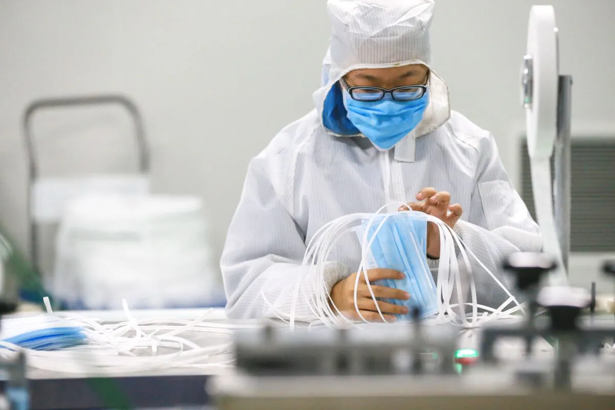 A worker produces protective face masks at a factory in Qingdao, China on Feb. 6, 2020. (STR/AFP via Getty Images)