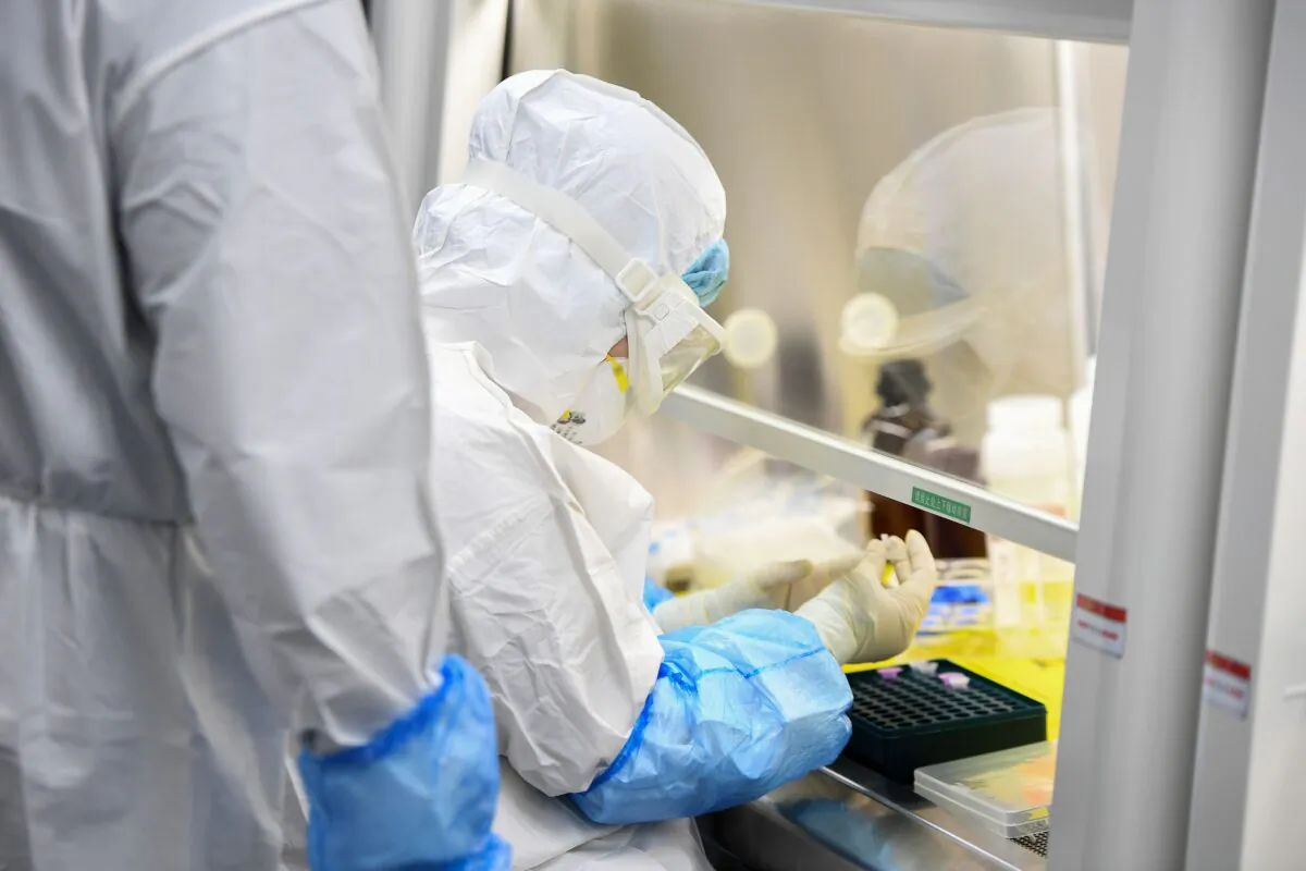 A laboratory technician working on samples from people to be tested for the new coronavirus at "Fire Eye" laboratory in Wuhan, China, on Feb. 6, 2020. (STR/AFP via Getty Images)