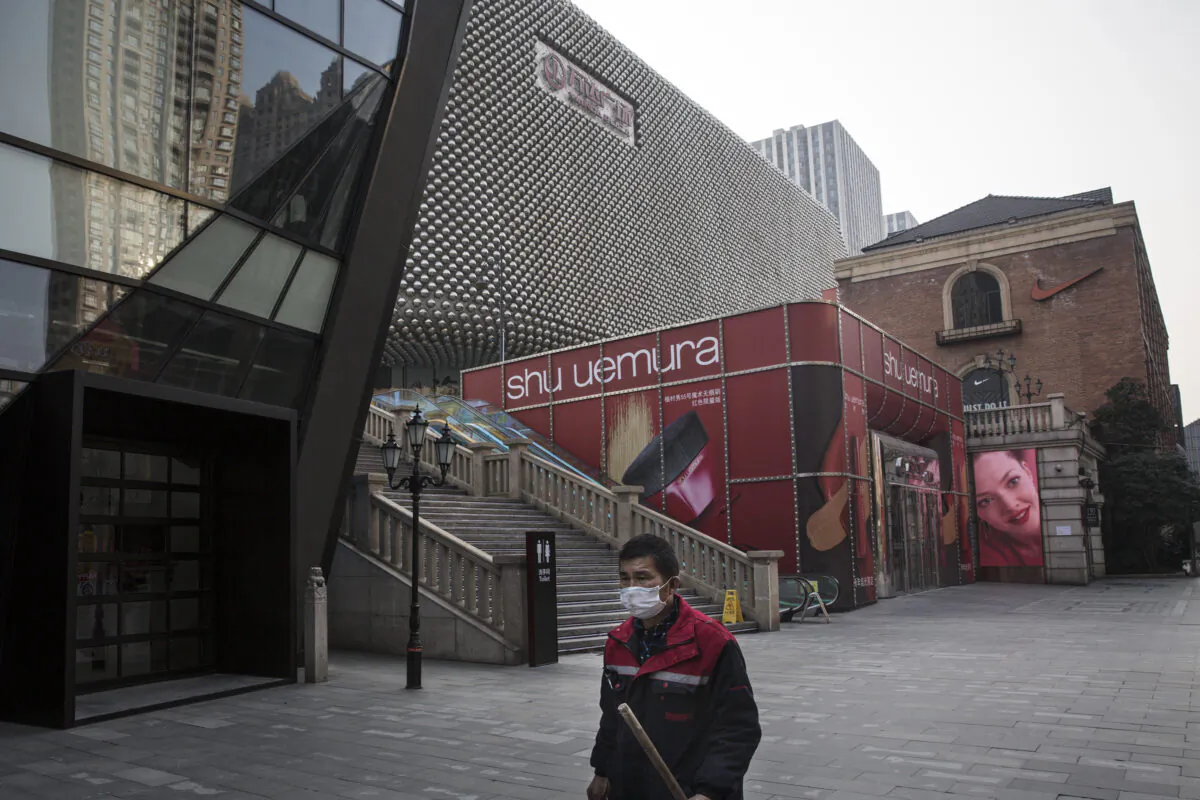A cleaner wears a protective mask as he walks down an empty street in Wuhan City, Hubei Province, China, on Feb. 3, 2020. (Getty Images)