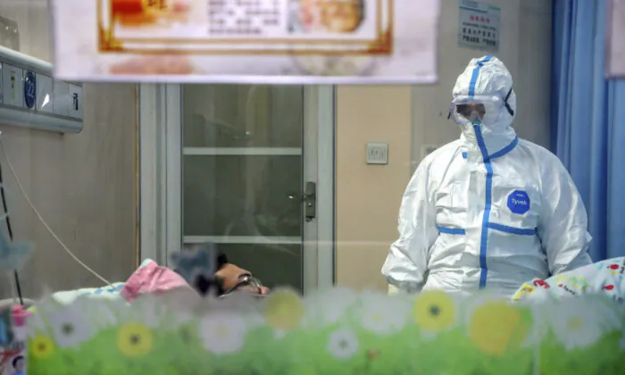 A doctor attends to a patient in an isolation ward at a hospital in Wuhan in central China's Hubei Province, on Jan. 30, 2020. (Chinatopix via AP)