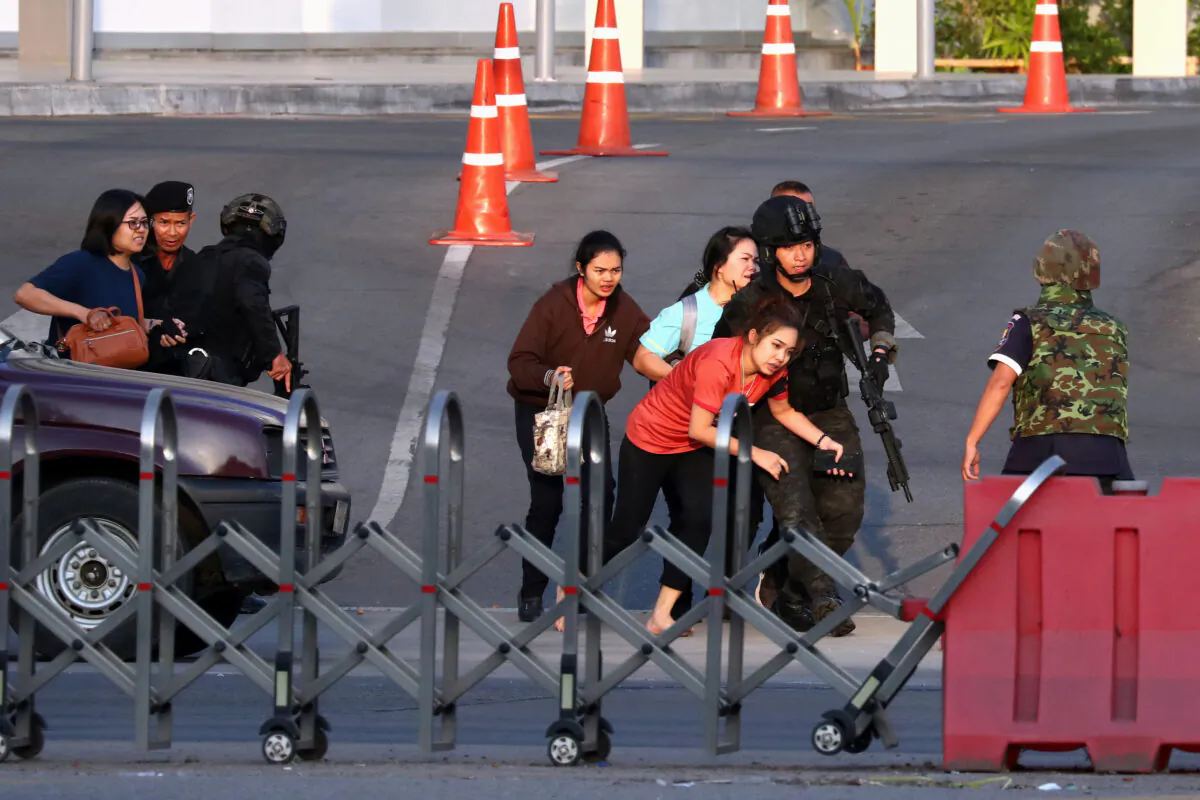 Thai security forces evacuate people who were stranded inside the Terminal 21 shopping mall following a gun battle, to try to stop a soldier on a rampage after a mass shooting, Nakhon Ratchasima, Thailand, on Feb. 9, 2020. (Athit Perawongmetha/Reuters