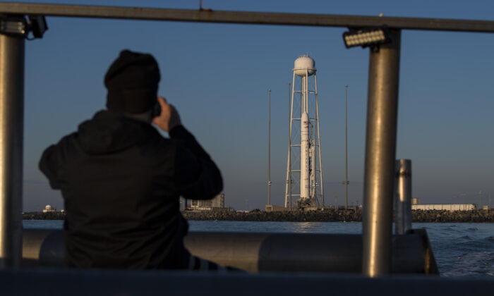 In this NASA handout, A Northrop Grumman Antares rocket carrying a Cygnus resupply spacecraft is seen out of the back of a boat at sunrise on Pad-0A, at NASA's Wallops Flight Facility in Virginia, on Feb. 9, 2020. (Aubrey Gemignani/NASA via Getty Images)