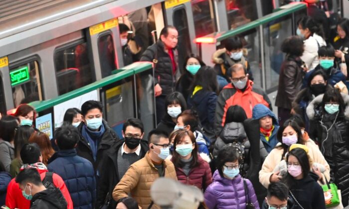 Mask-clad commuters get off a train at a Mass Rapid Transit (MRT) stop in Taipei following the Lunar New Year holidays on Jan. 30, 2020. (Sam Yeh/AFP via Getty Images)