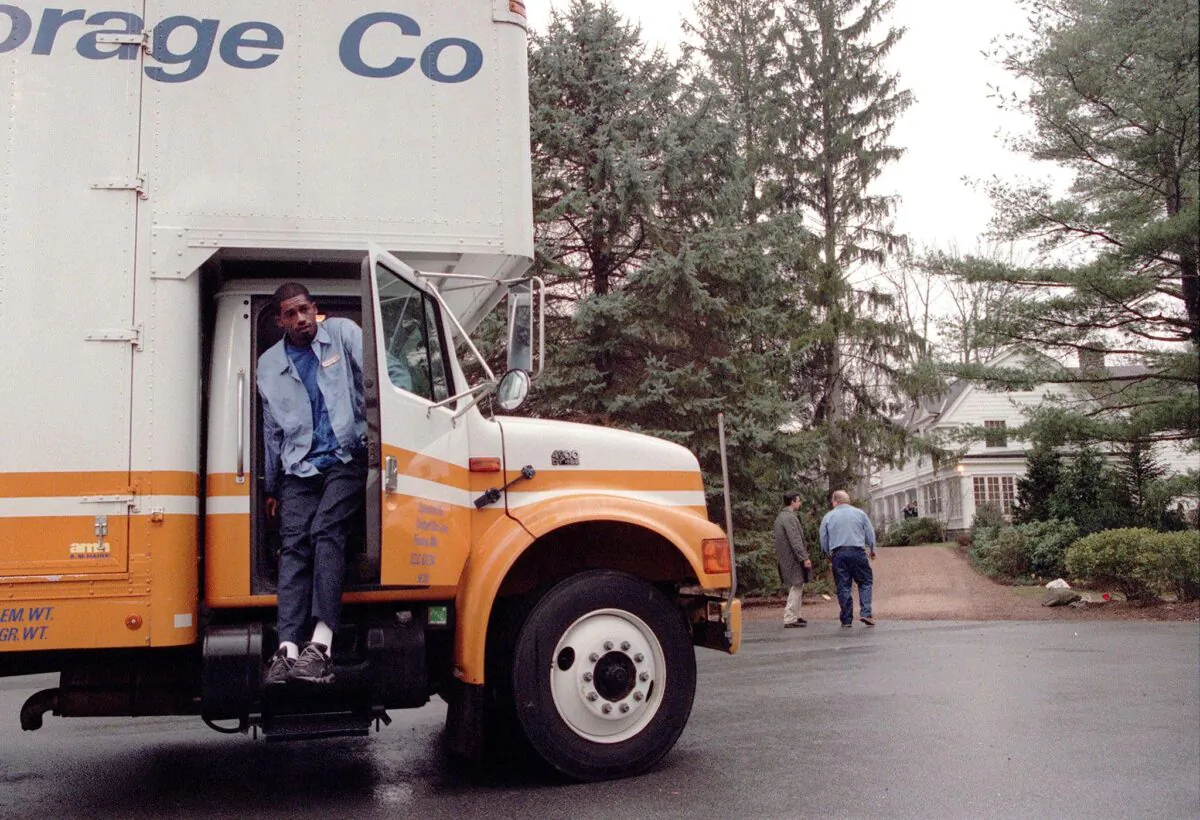 A United Van Lines employee gets out of a moving van in Chappaqua, New York, on Jan. 4, 2000. (DOUG KANTER/AFP via Getty Images)