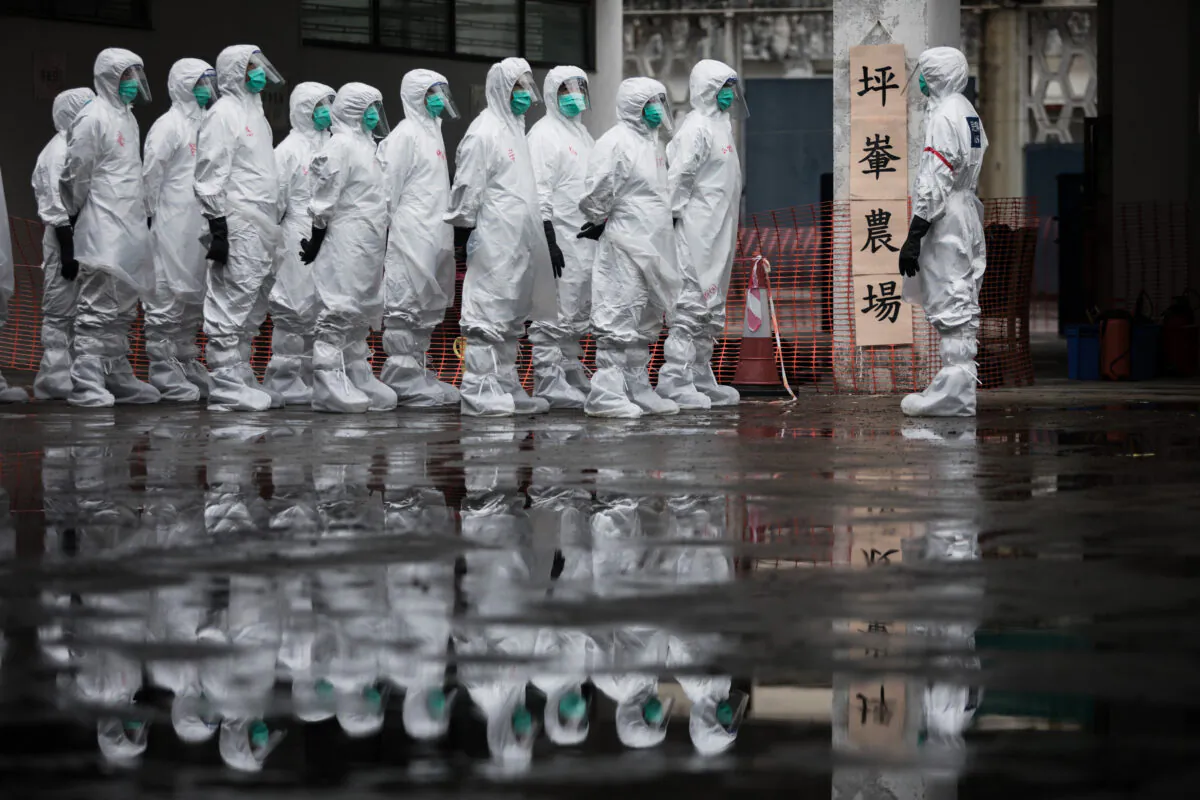 Volunteers from the Civil Aid Service wearing protective clothing take part in a chicken cull demonstration as part of an emergency response exercise in Hong Kong on May 21, 2017. (Dale de la Rey/AFP via Getty Images)