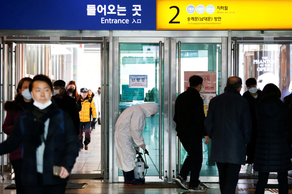 An employee from a disinfection service company sanitizes at the Seoul Railway Station in Seoul, South Korea, on Feb. 10, 2020. (Heo Ran/Reuters)