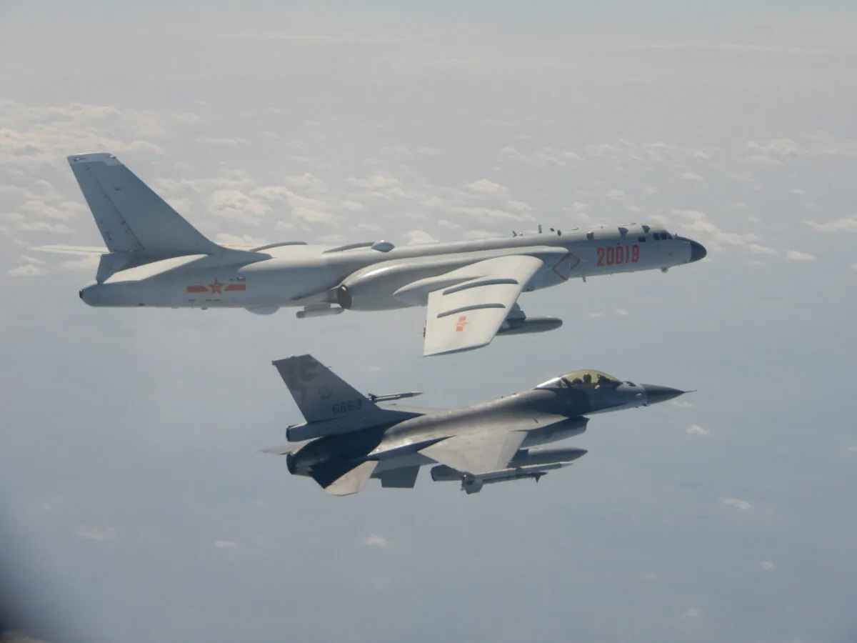 An H-6 bomber of Chinese PLA Air Force flies near a Taiwan F-16 in this Feb. 10, 2020 handout photo provided by Taiwan Ministry of National Defense. In a statement, the ministry said Chinese J-11 fighters and H-6 bombers flew into the Bashi Channel to the south of Taiwan, then out into the Pacific before heading back to base via the Miyako Strait. (Taiwan Ministry of National Defense/Handout via Reuters)