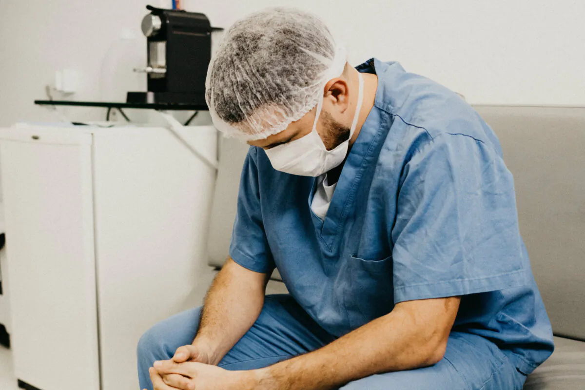 A file photo of a man wearing blue scrubs. A study published by UC–San Diego researchers on Feb. 3, 2020, shows nurses are at a higher risk of suicide than the general population in the United States. (Jonathan Borba/ Pexels)