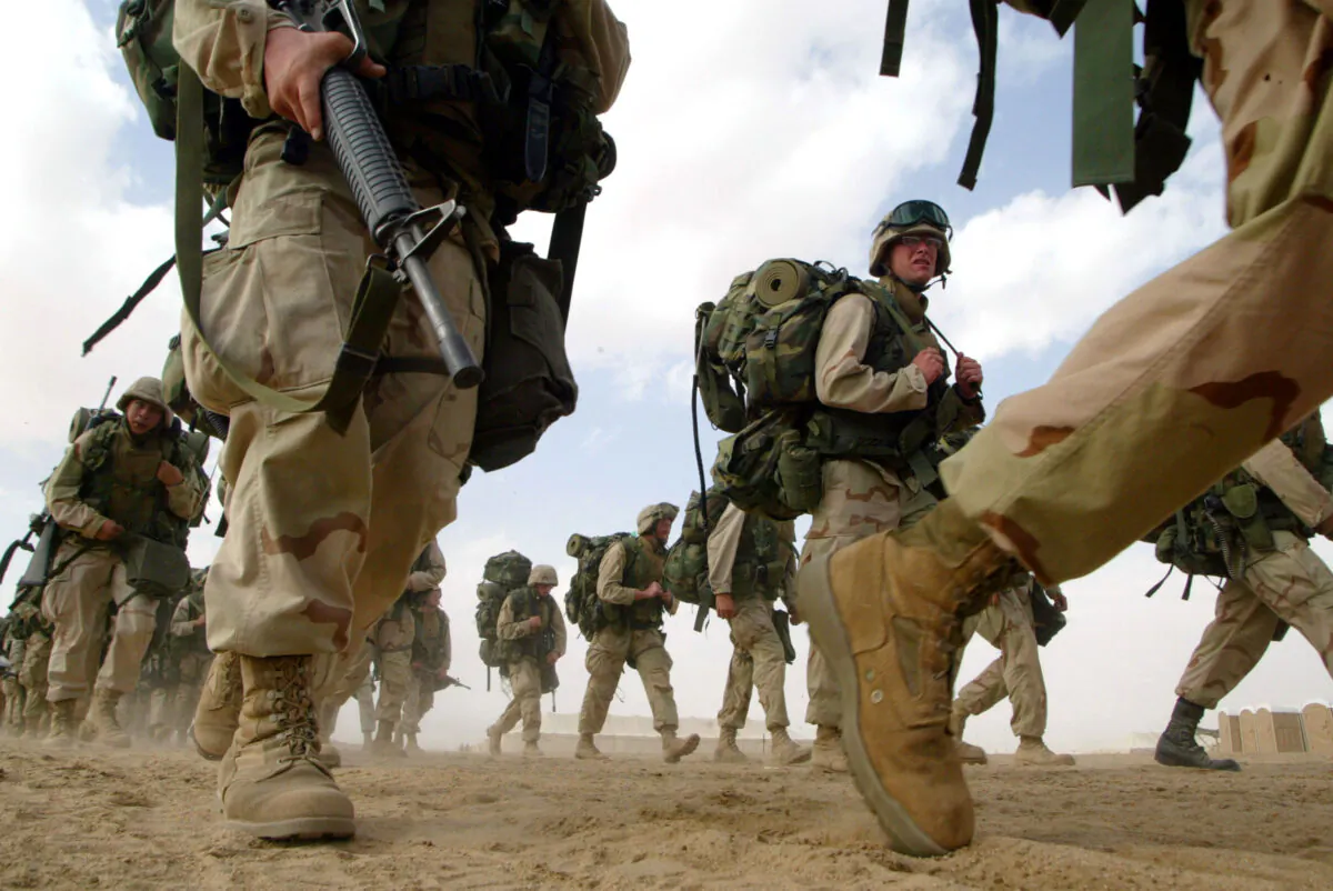 U.S. Marines from the 1st Marine Division return from a six-mile march near the Iraqi border in Kuwait on Feb. 15, 2003. (Joe Raedle/Getty Images)