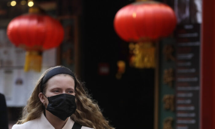A woman wears a mask as she walks near Chinatown in London on Feb. 7, 2020. (Kirsty Wigglesworth/AP Photo)