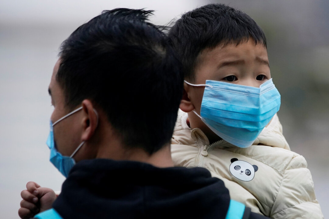 Passengers wearing masks walk outside the Shanghai railway station in Shanghai, China, as the country is hit by an outbreak of the new coronavirus, Feb. 8, 2020. (REUTERS/Aly Song)