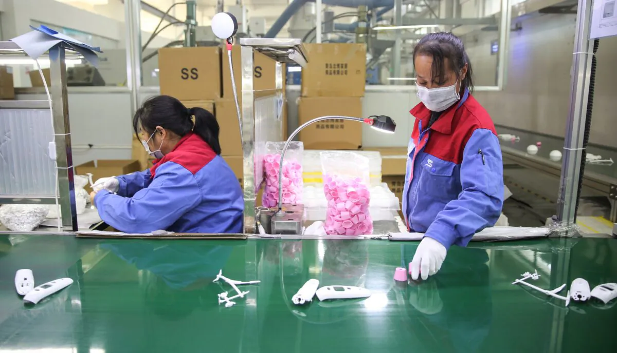 Workers are producing thermometers at a factory in Shandong Province, China, on Feb. 10, 2020. (STR/AFP via Getty Images)
