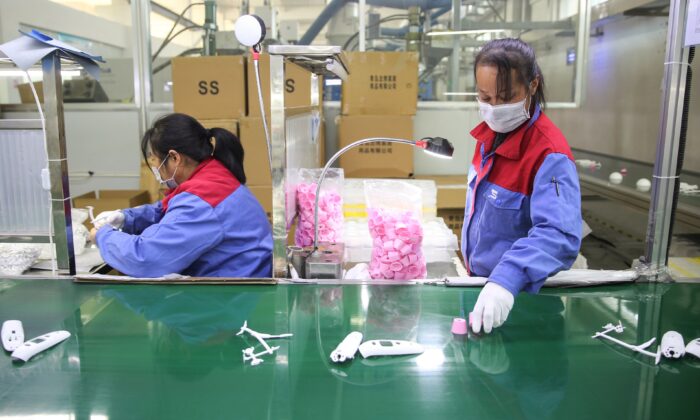 Workers are producing thermometers at a factory in Shandong Province, China, on Feb. 10, 2020. (STR/AFP via Getty Images)