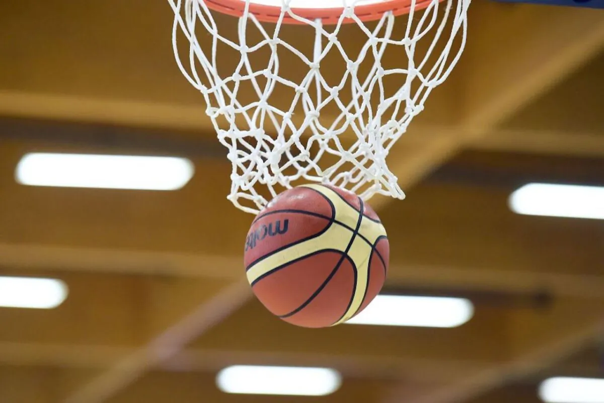 A basketball goes through a hoop in a 2017 file photo. (Nicolas Tucat/AFP/Getty Images)

