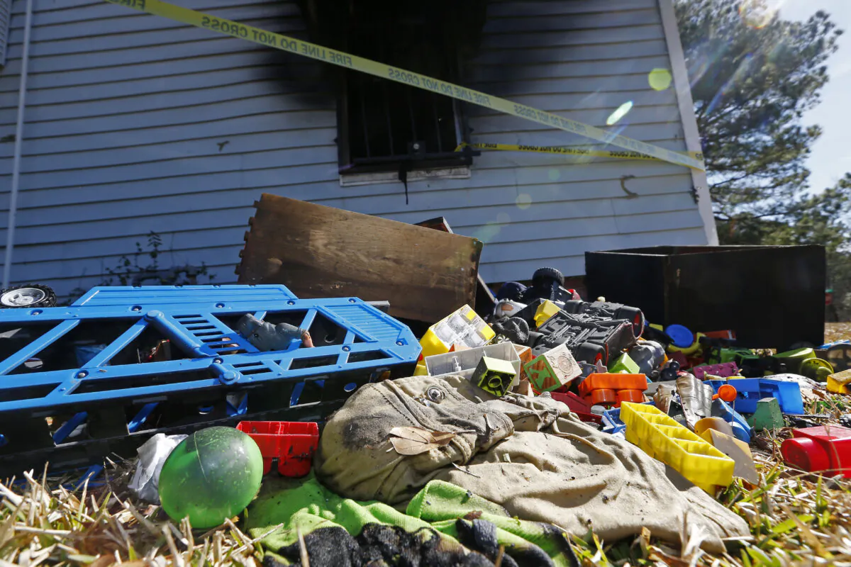 Burned children's clothing, furnishings exterior of a house at the scene of a fatal fire in Clinton, Miss., on Feb. 8, 2020. (Rogelio V. Solis/AP Photo)