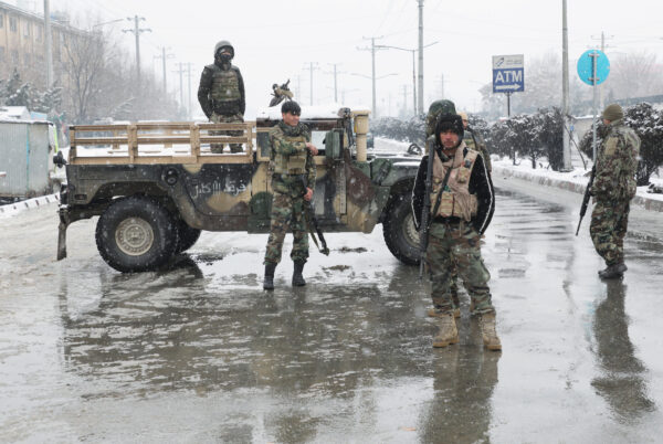 Afghan security forces keep watch near the site of a suicide attack in Kabul