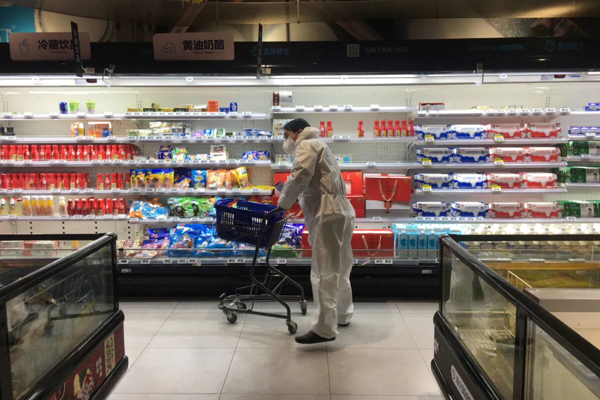 A customer pushes a cart while shopping inside a supermarket of Alibaba's Hema Fresh chain, following an outbreak of the novel coronavirus in Wuhan, Hubei province, China on 11, 2020. (Stringer/Reuters)