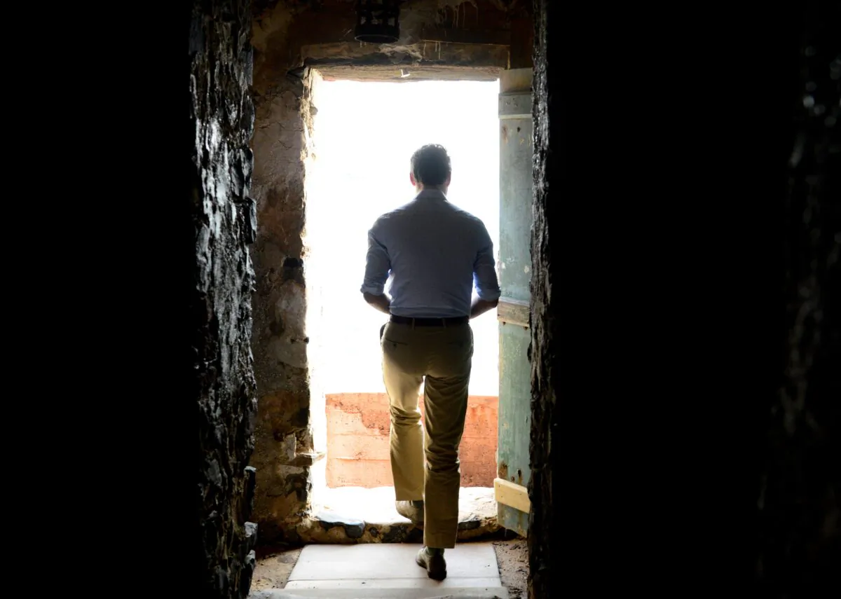 Prime Minister Justin Trudeau looks out from the Door of No Return at the slave house on Goree Island, Dakar, Senegal, on Feb. 12, 2020. (The Canadian Press/Sean Kilpatrick)