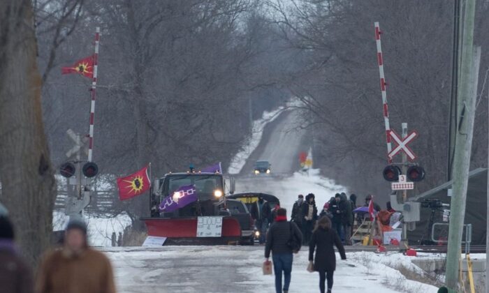 People arrive at the train track blockade in Tyendinaga Mohawk Territory near Belleville, Ontario, on Feb. 11, 2020, in support of Wet'suwet'en's blockade of a natural gas pipeline in northern B.C. (The Canadian Press/Lars Hagberg)