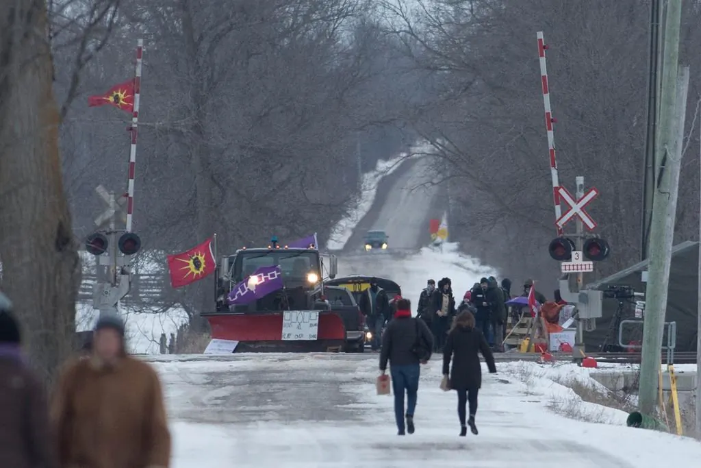 People arrive at the train track blockade in Tyendinaga Mohawk Territory near Belleville, Ontario, on Feb. 11, 2020, in support of Wet'suwet'en's blockade of a natural gas pipeline in northern B.C. (The Canadian Press/Lars Hagberg)