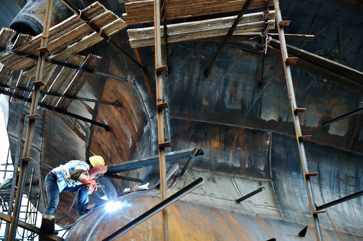 A Chinese worker welding at a shipbuilding yard in Chongqing, China on Sept. 21, 2015. (STR/AFP via Getty Images)