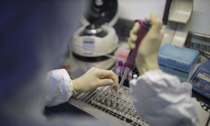 A medical staffer works with test systems for the diagnosis of coronavirus, at the Krasnodar Center for Hygiene and Epidemiology microbiology lab in Krasnodar, Russia on Feb. 4, 2020. (AP Photo)