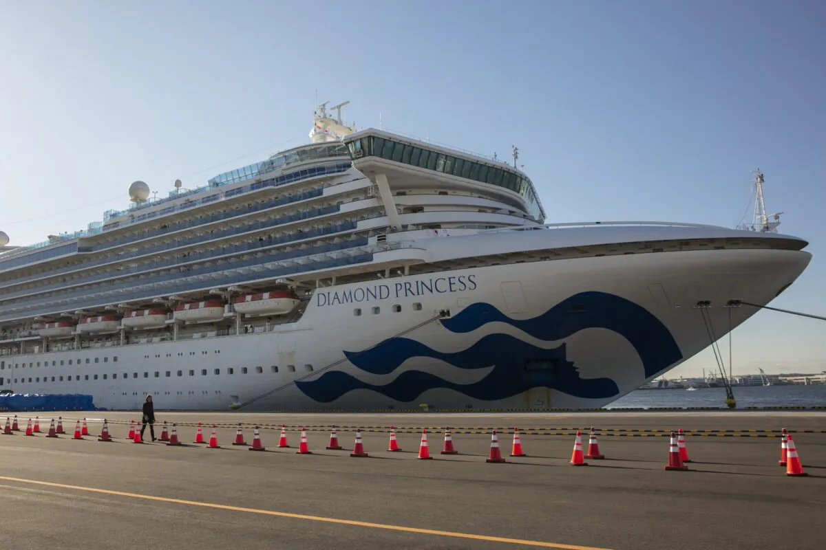 A reporter walks near the quarantined Diamond Princess cruise ship in Yokohama, near Tokyo, on Feb. 11, 2020. (Jae C. Hong/AP)
