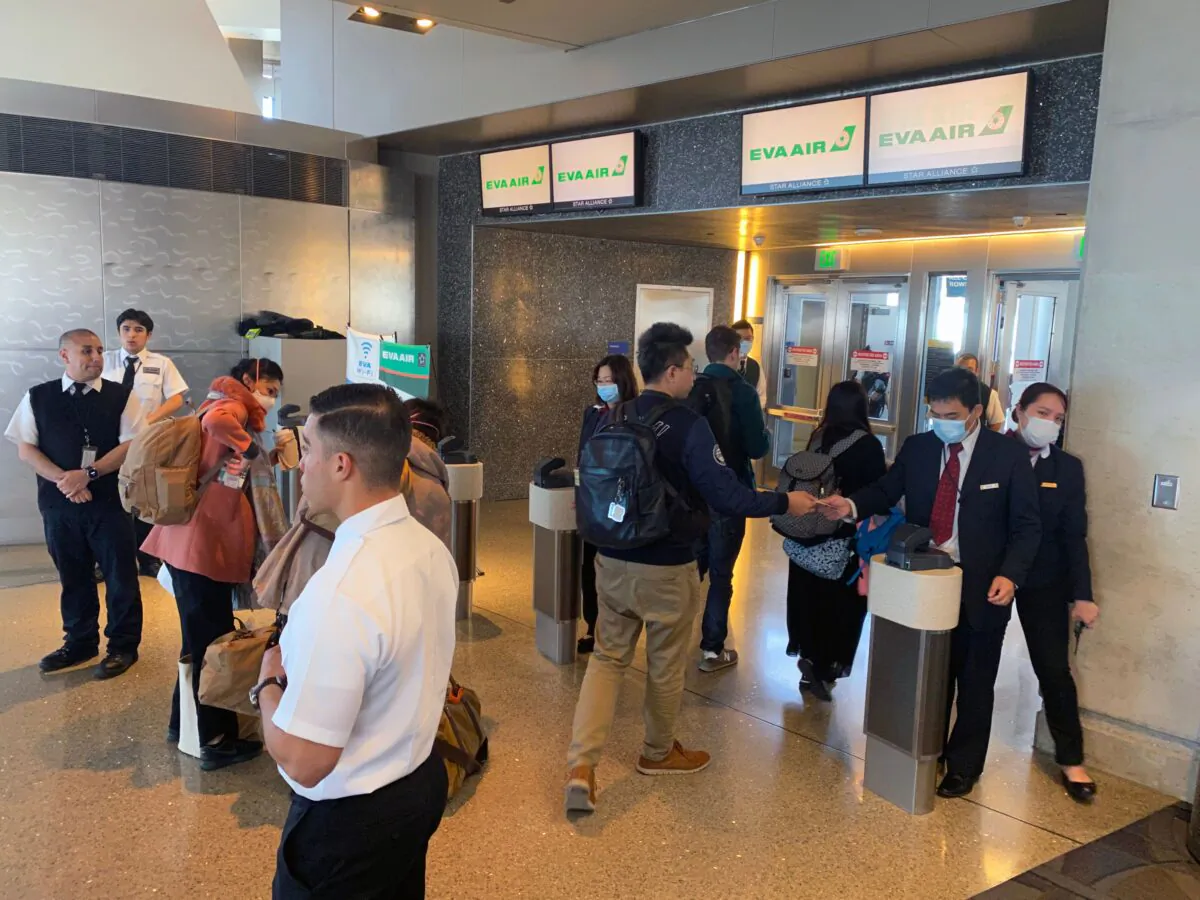 EVA Air employees are seen at Los Angeles International Airport (LAX) wearing masks, to prevent the coronavirus infection, COVID-19 in Los Angeles, California on Feb. 12, 2020. (Daniel Slim/AFP via Getty Images)