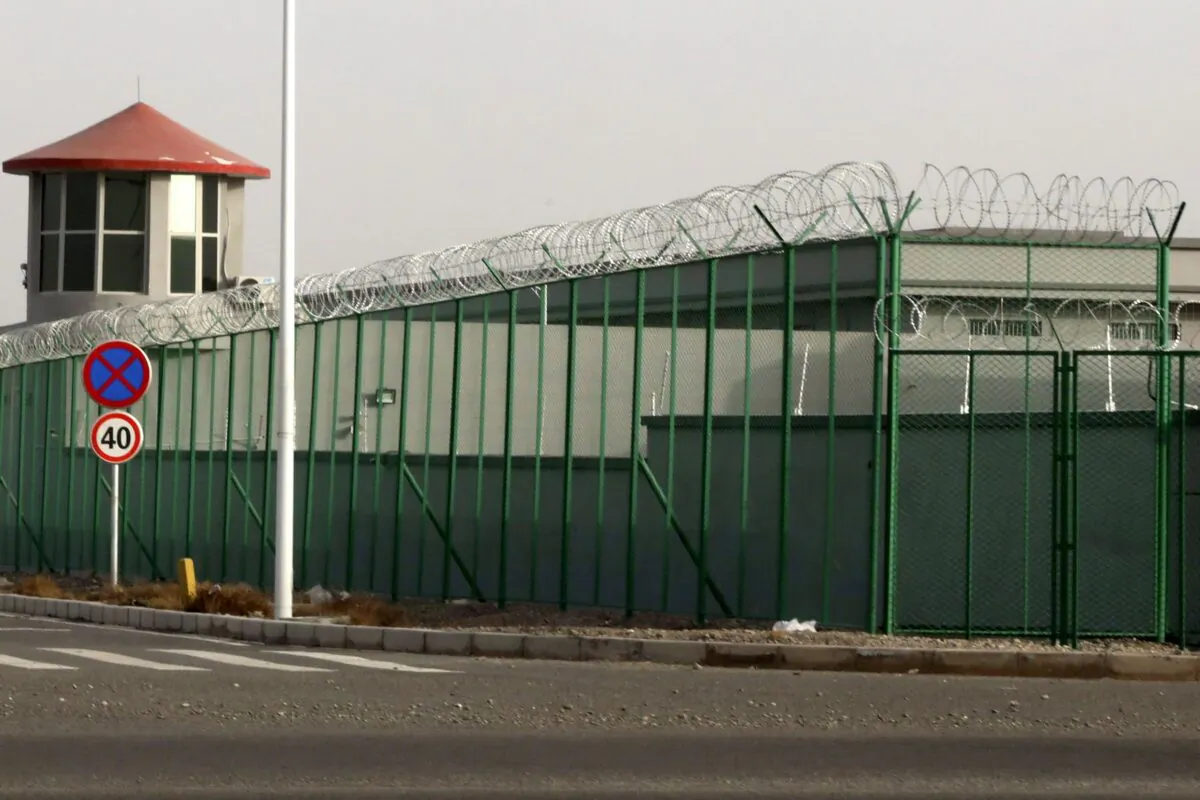 A guard tower and barbed wire-topped fences at an internment facility in the Kunshan Industrial Park in Artux, western China's Xinjiang region, on Dec. 3, 2018. Ng Han Guan/AP Photo