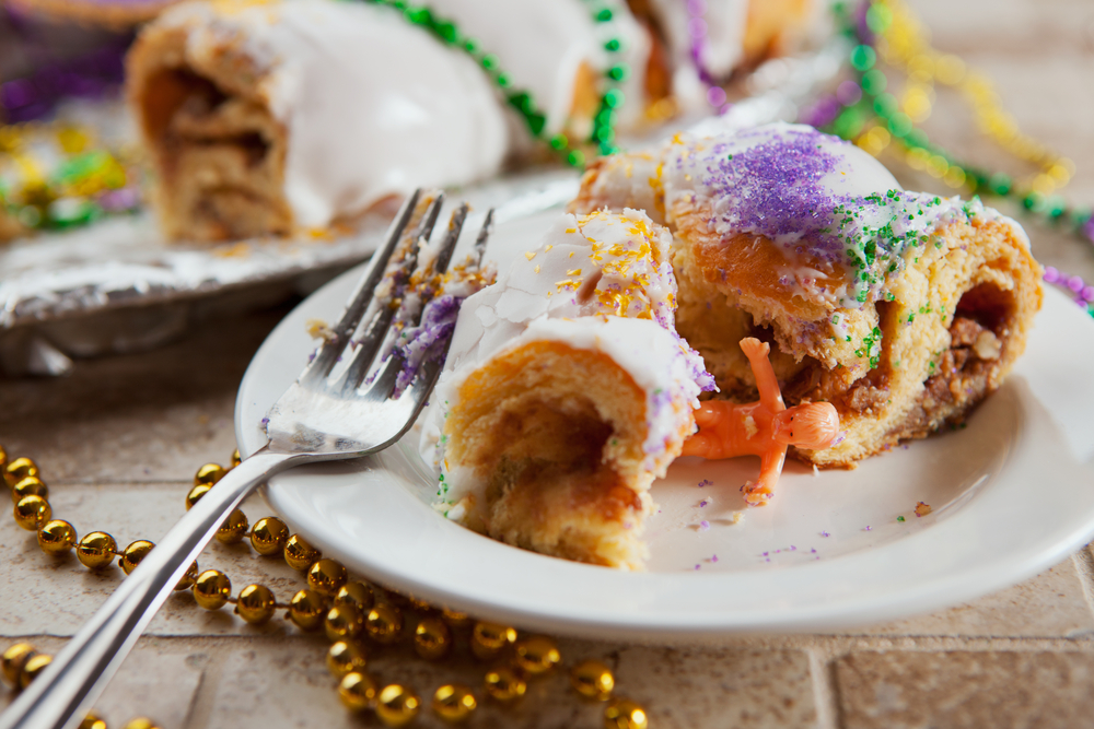 The lucky person who gets 'the baby' in their slice is blessed with good fortune—and the responsibility to buy the next king cake. (Shutterstock)  