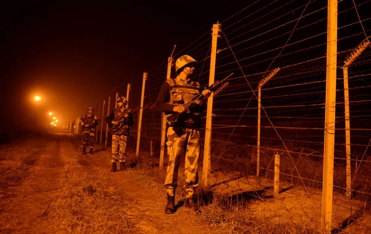 An Indian Border Security Force (BSF) soldiers patrol along the border fence at an outpost along the India-Pakistan border in Suchit-Garh, 36 kms southwest of Jammu on Jan. 11, 2013. (Tauseef Mustafa/AFP via Getty Images)