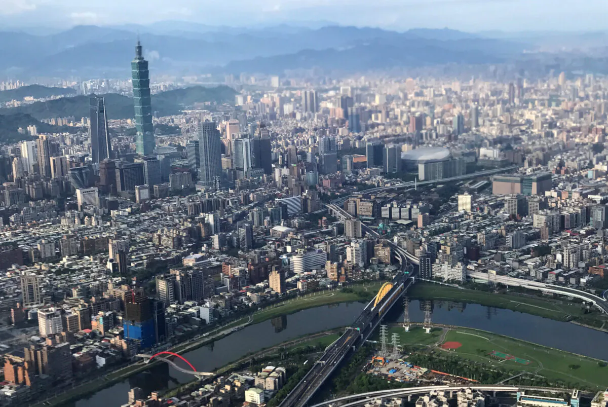 Nan Shan Plaza (L) and Taiwan's landmark building Taipei 101 are pictured through the window of an airplane, in Taipei, Taiwan on Aug. 19, 2018. (Tyrone Siu/Reuters)