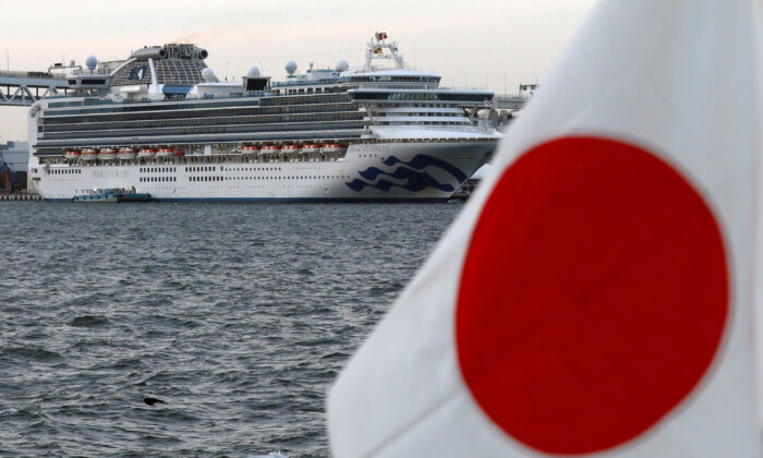 The cruise ship Diamond Princess is pictured beside a Japanese flag as it lies at anchor while workers and officers prepare to transfer passengers who tested positive for coronavirus, at Daikoku Pier Cruise Terminal in Yokohama, Japan, on Feb. 12, 2020. (Kim Kyung-Hoon/ Reuters/File Photo)