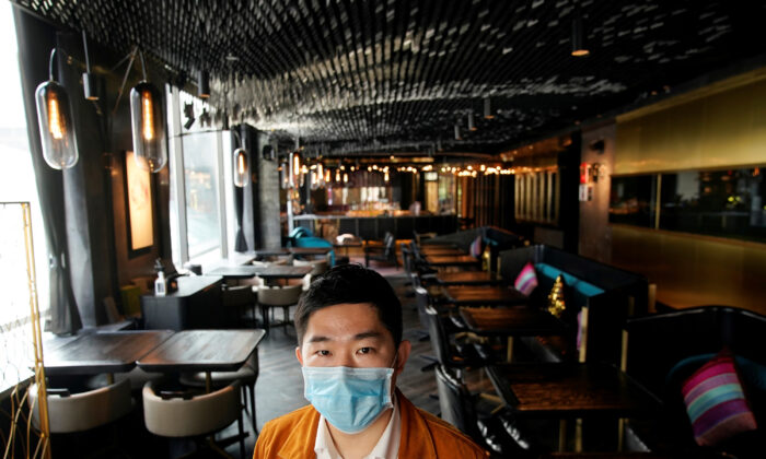 Bill Hu, founder and CEO of seul & SEUL restaurant, wears a mask and poses for pictures in downtown Shanghai, China, as the country is hit by an outbreak of a new coronavirus, on Feb. 12, 2020. (/Aly Song/Reuters)