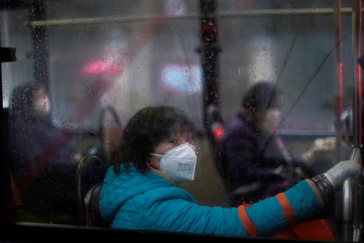 Women wearing masks are seen on a bus in downtown Shanghai, China, as the country is hit by an outbreak of a new coronavirus on Feb. 13, 2020. (Aly Song/Reuters)